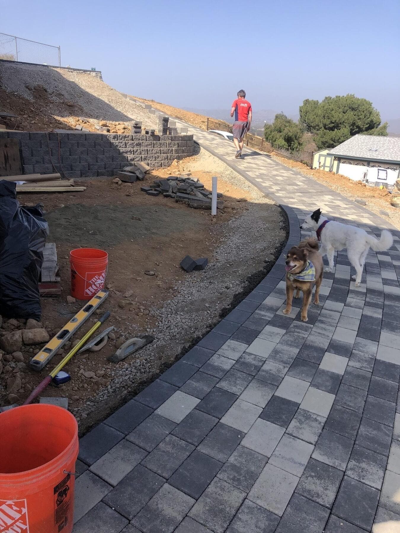 Crew setting pavers along the new retaining wall