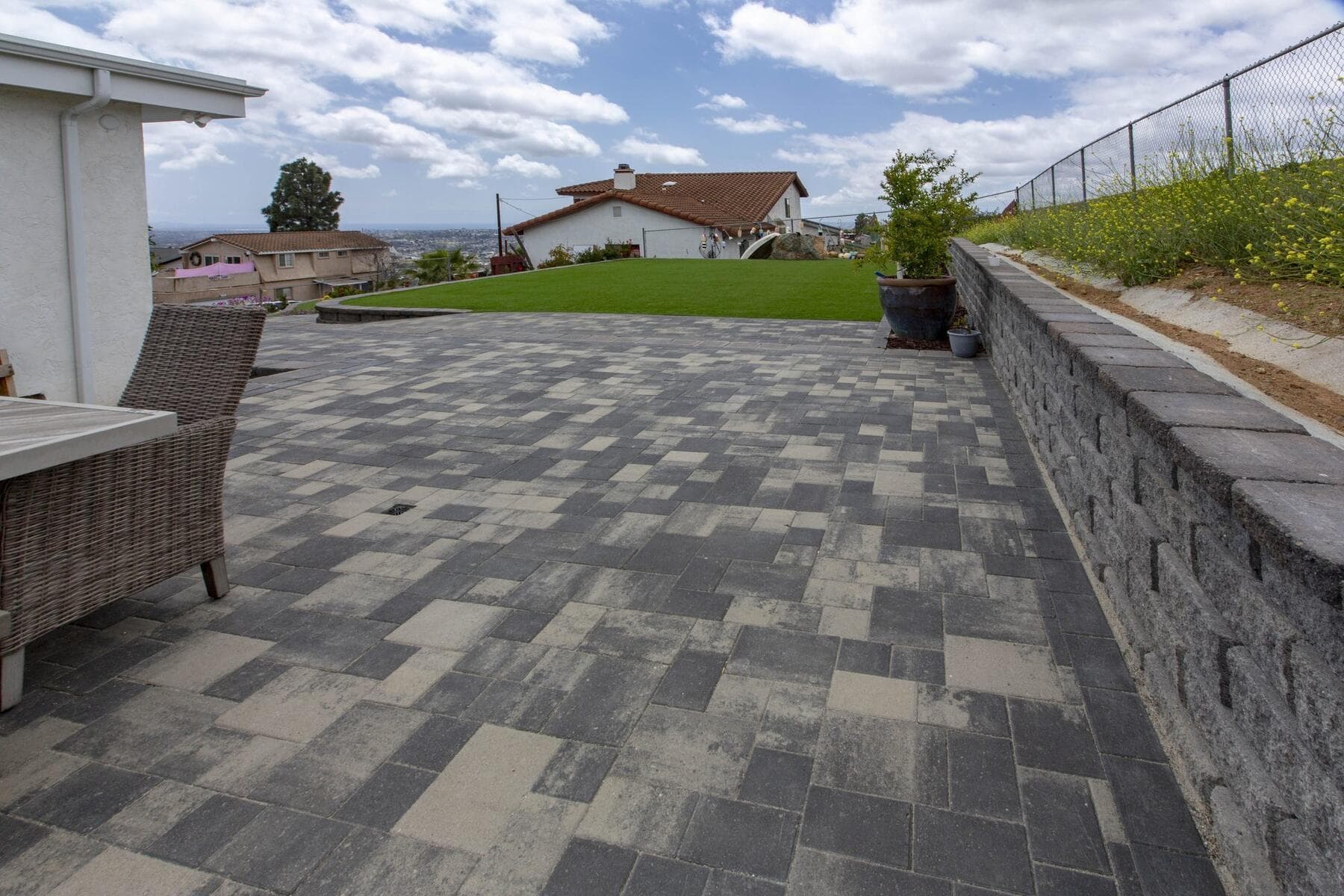 Finished paver patio looking out to the turf terrace and Spring Valley