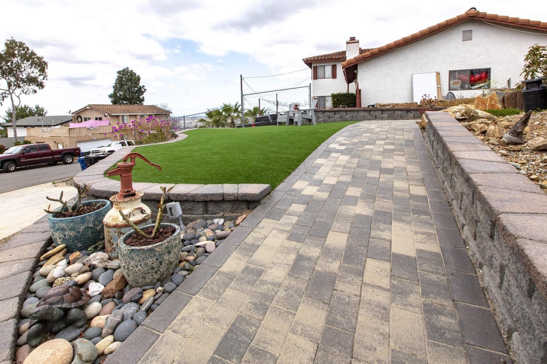 Paver walk between planting and the turf terrace