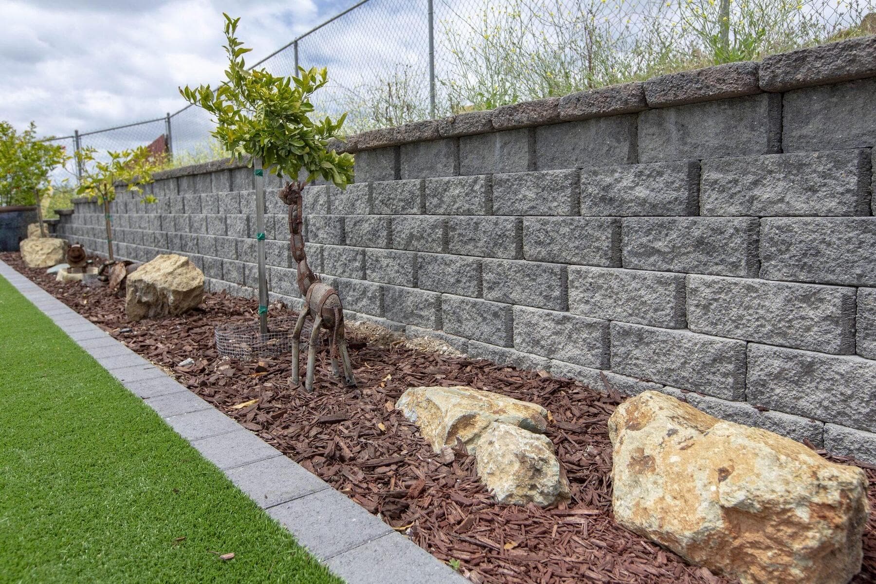 Planting bed and boulders along the RidgeStone wall