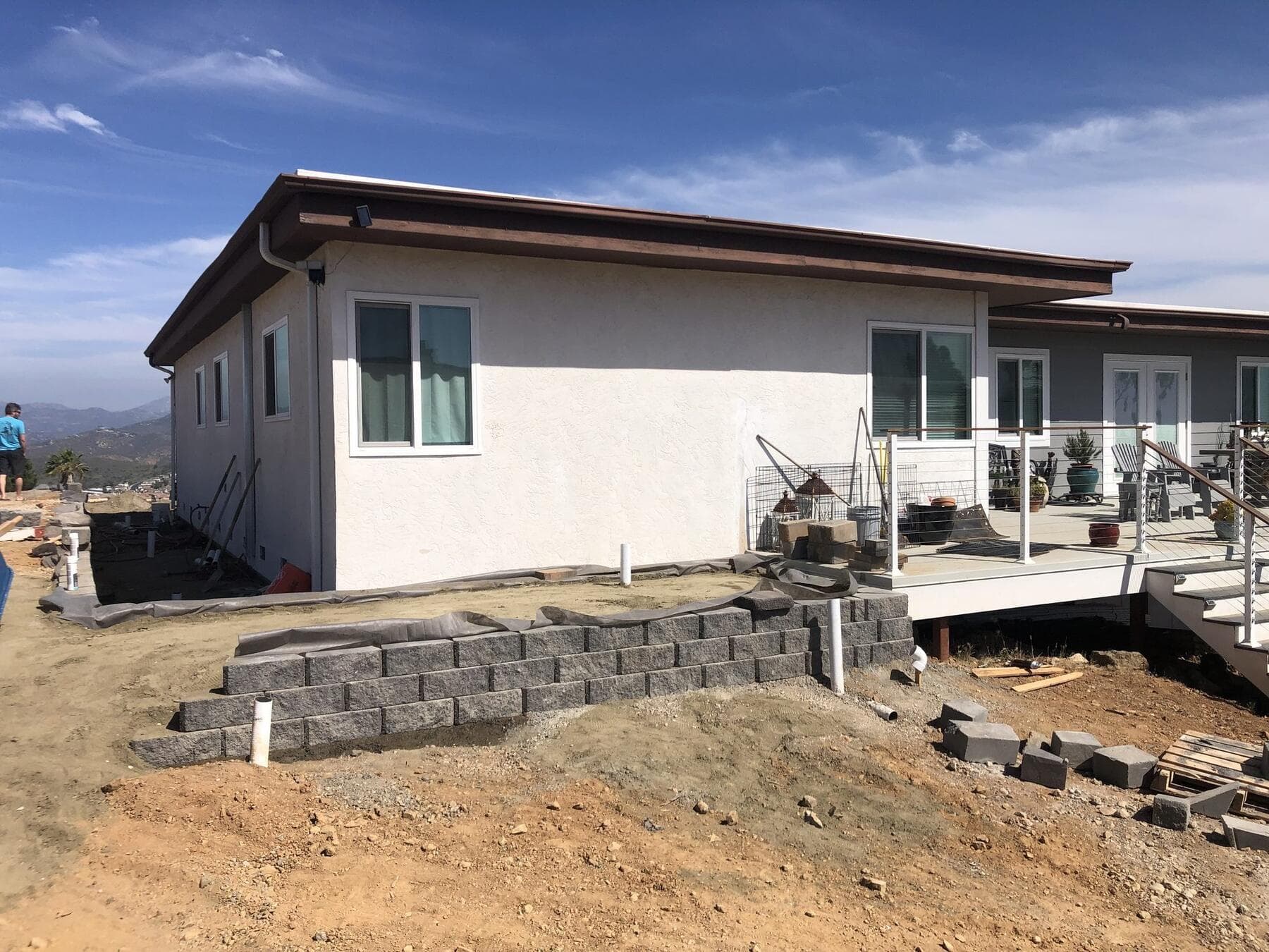 RidgeStone retaining wall going up along the house at Dictionary Hill