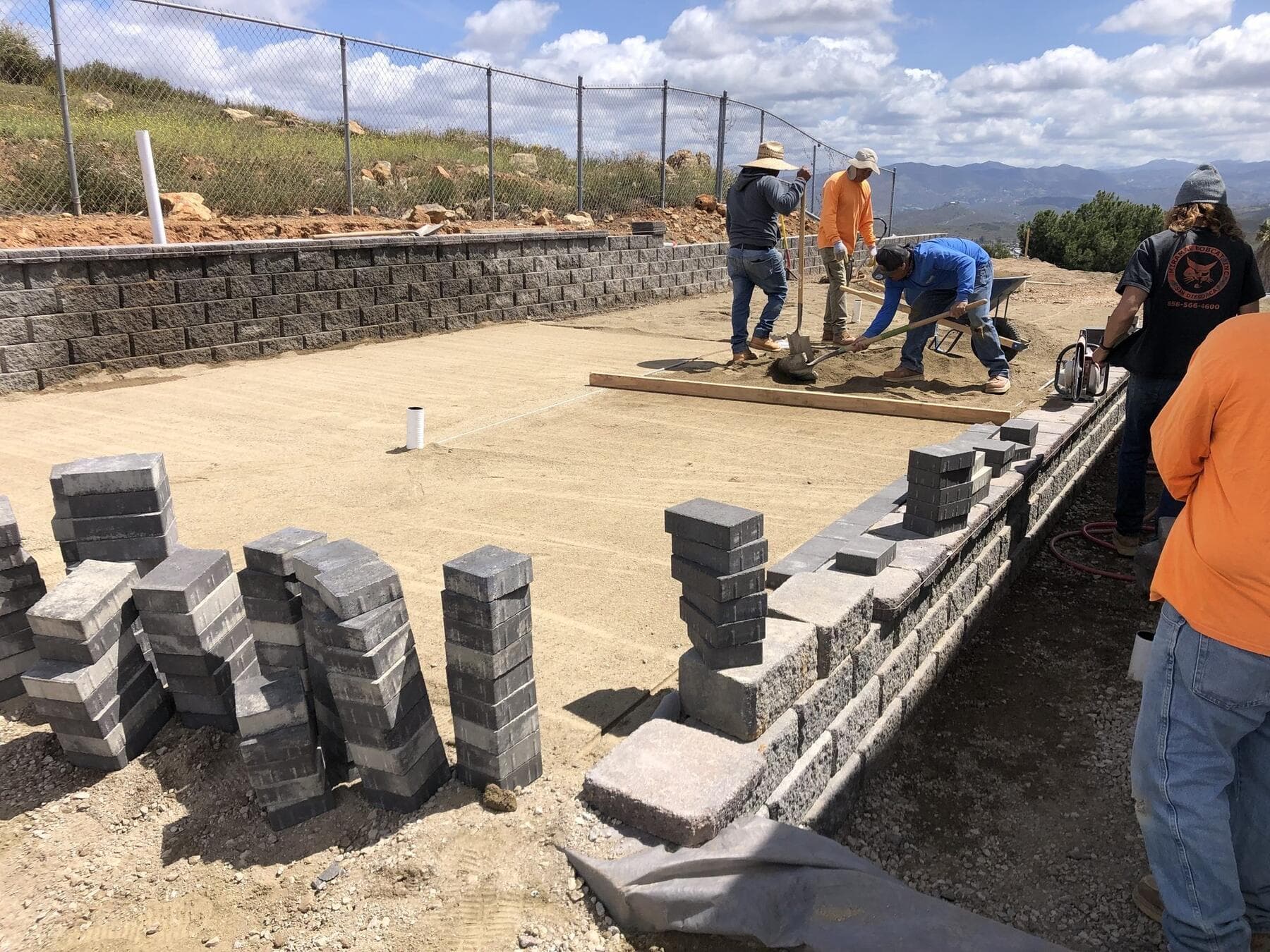 In-house crew screeding bedding sand inside the new retaining walls