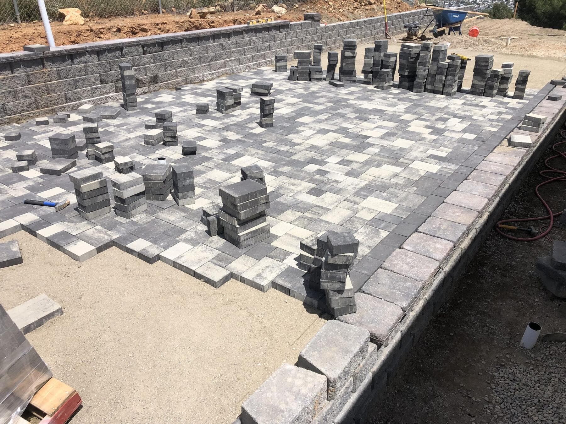 Catalan pavers going down on the prepared base at Dictionary Hill