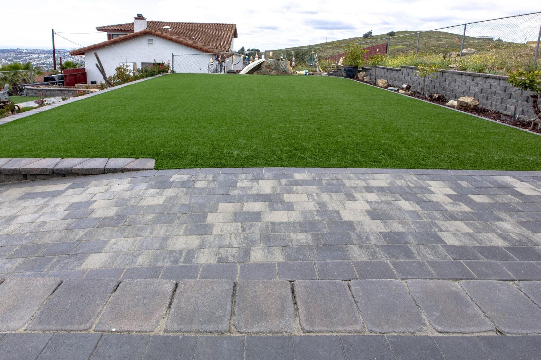 Turf field meeting the paver patio at Dictionary Hill