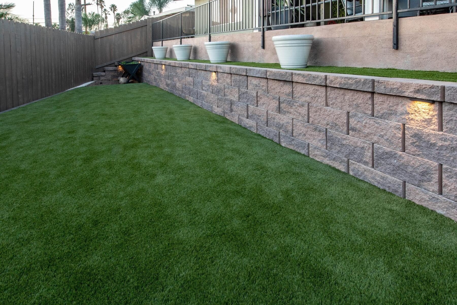 Turf lawn below the finished block retaining wall