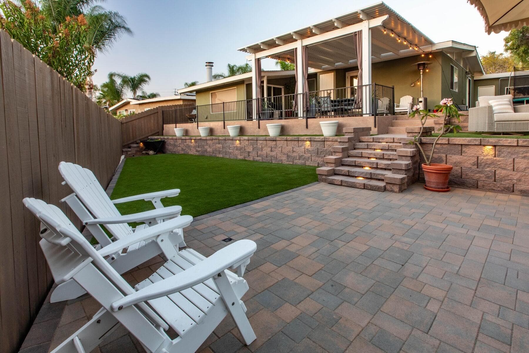 Paver patio and seating on the upper terrace above the retaining wall