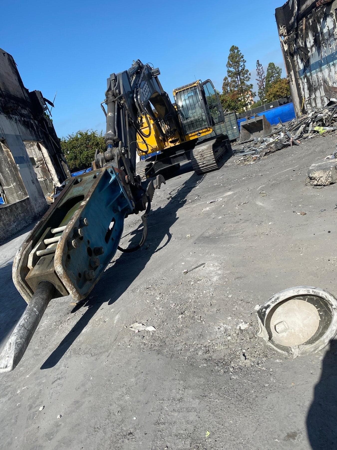 Breaker attachment on a Deere excavator at the La Mesa demolition