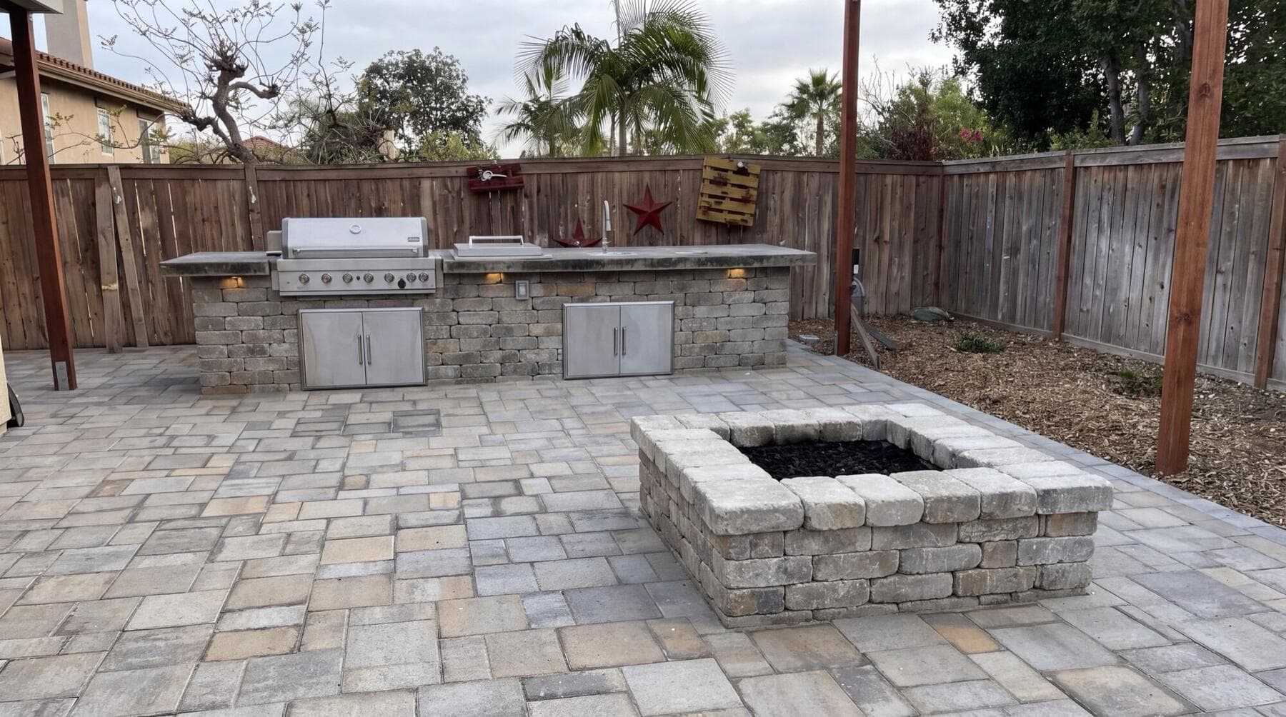 Square block firepit and outdoor kitchen on the Oceanside paver patio