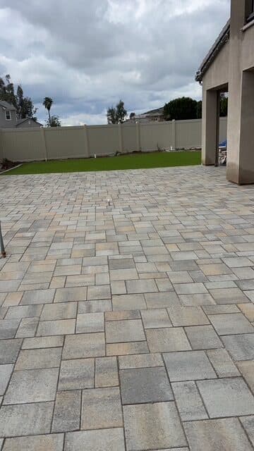 Catalina Grana paver patio running toward turf and the rear fence