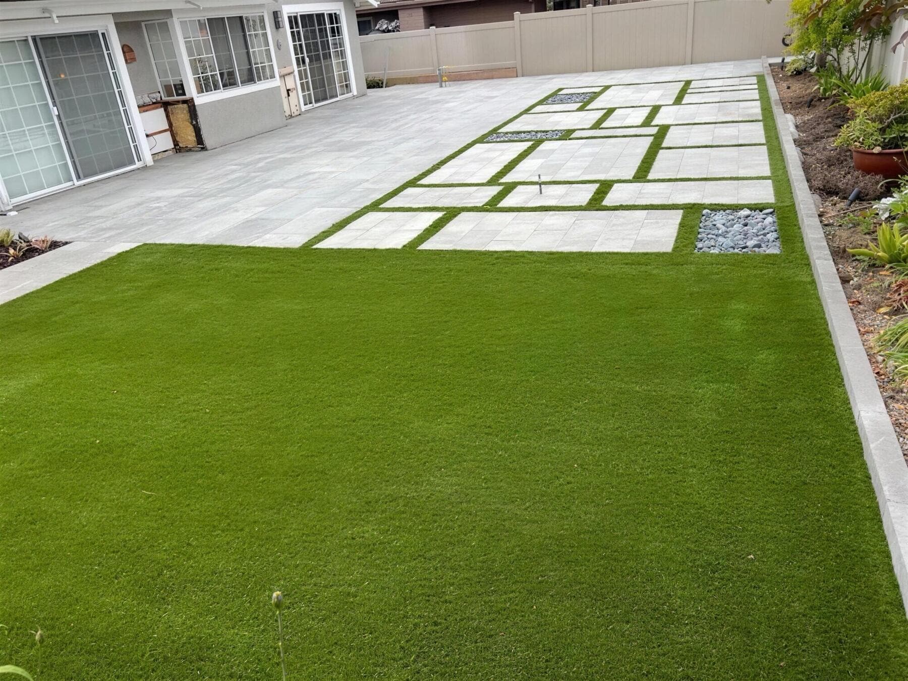 Integriturf lawn running up to the slab patio and house