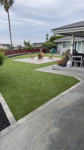 Lounge chairs on the paver patio in turf with a DG walk in the foreground