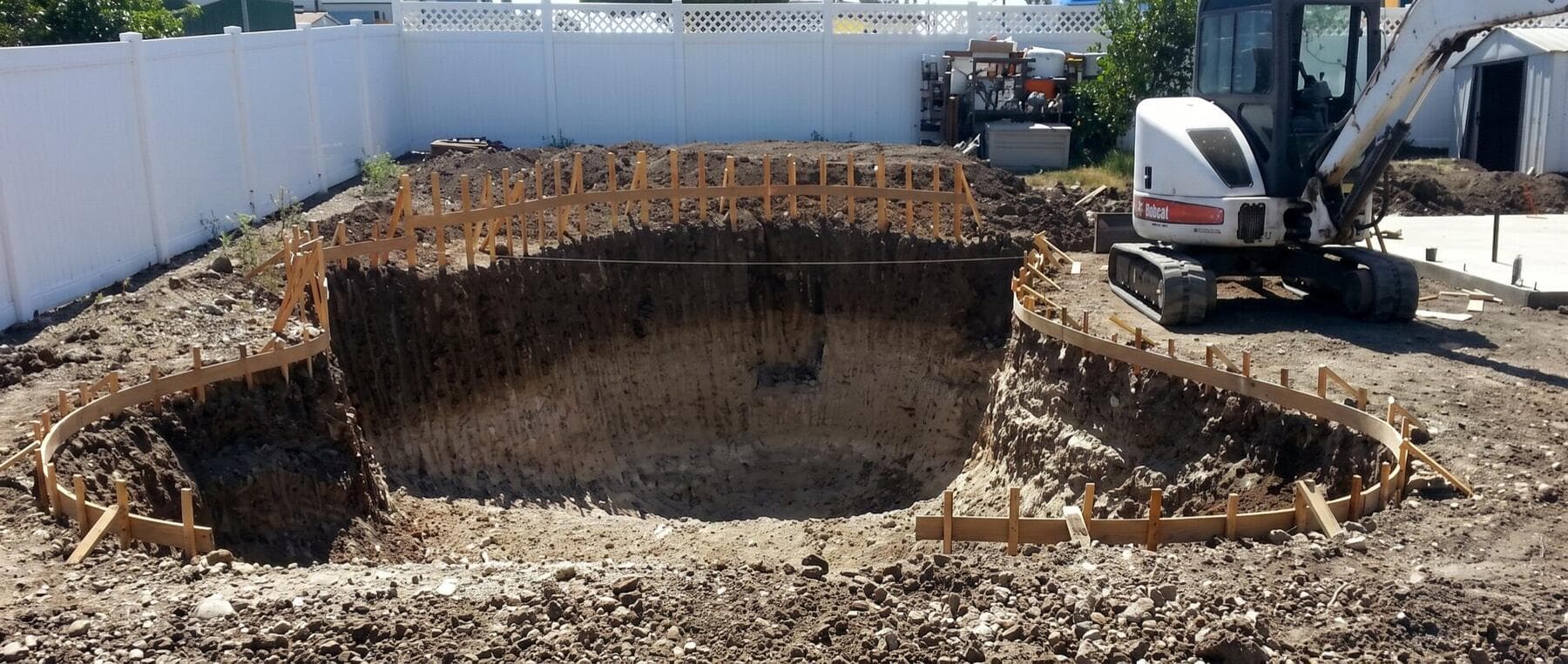 Residential pool excavation with formwork and a compact excavator